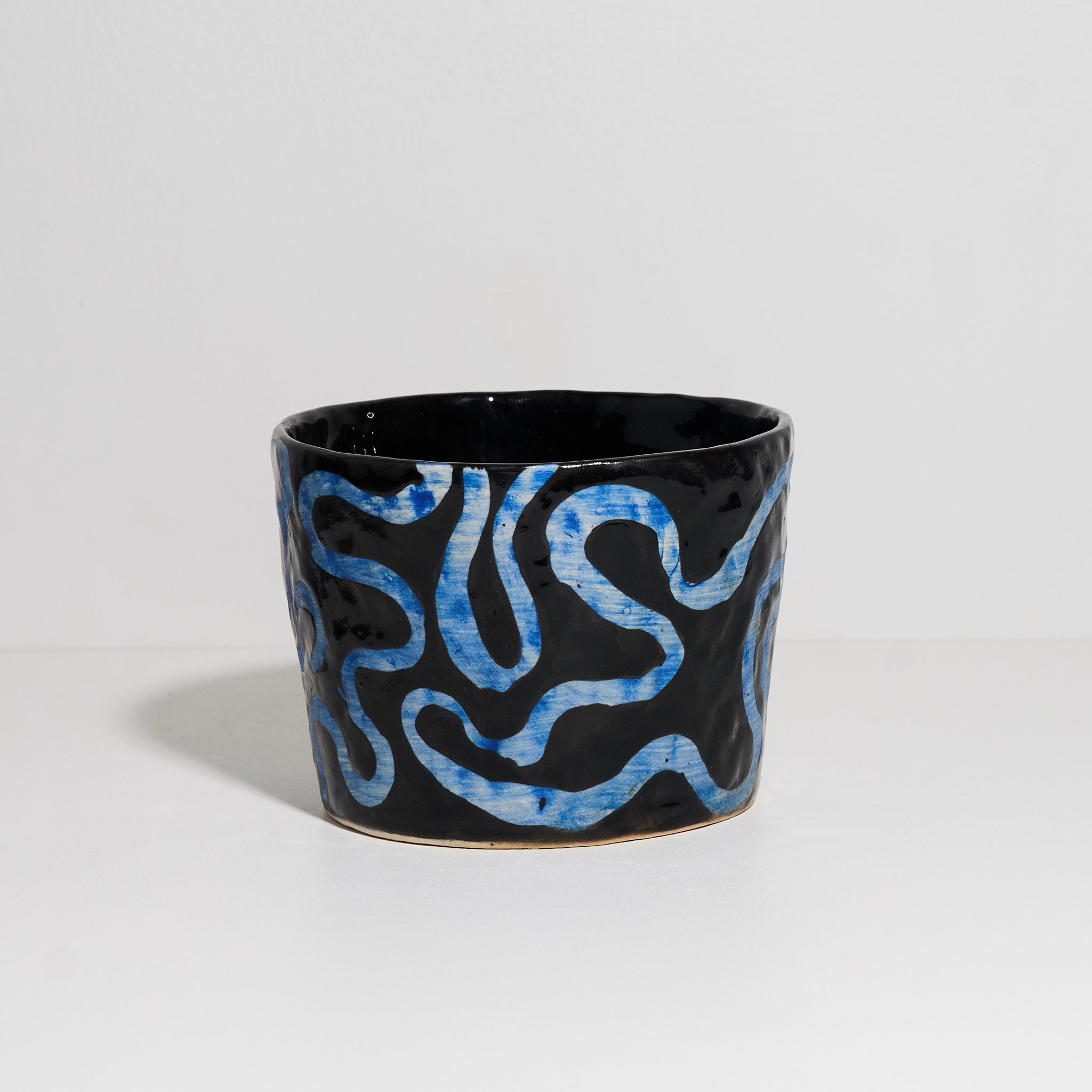 Cup with Blue Wiggles Under Black Glaze